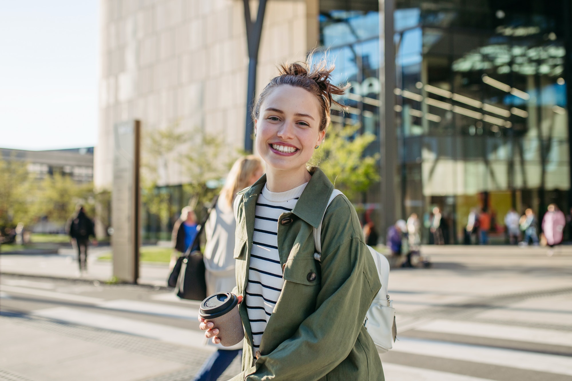 Portrait of young woman in a city.